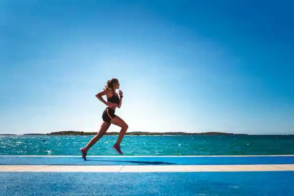 Woman running showing strong leg muscle Stockport